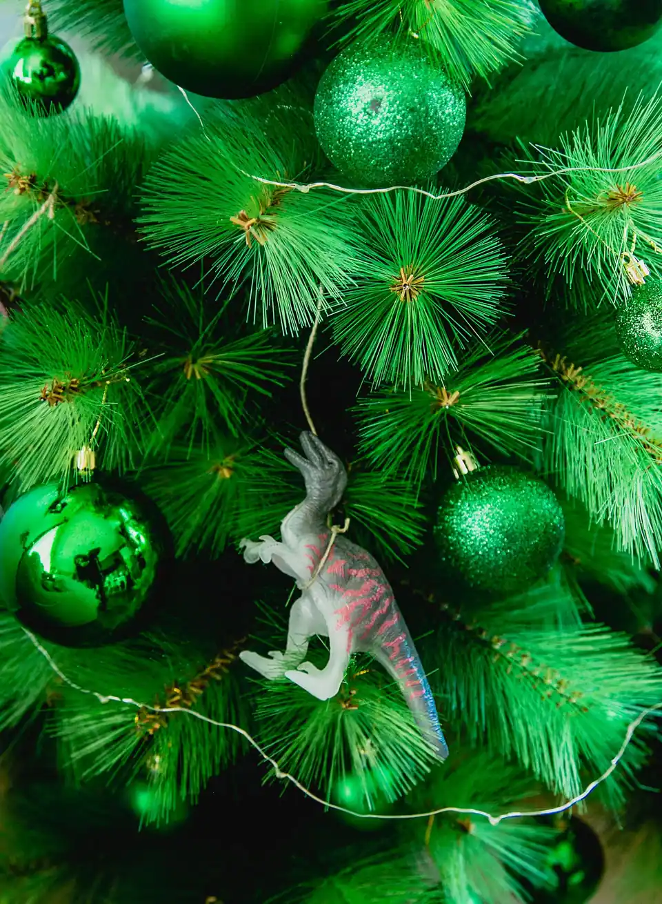 Toy dinosaur ornament on a Christmas tree