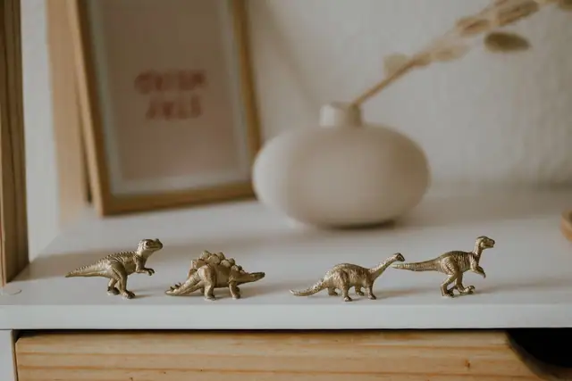 Gold dinosaur figures on a shelf